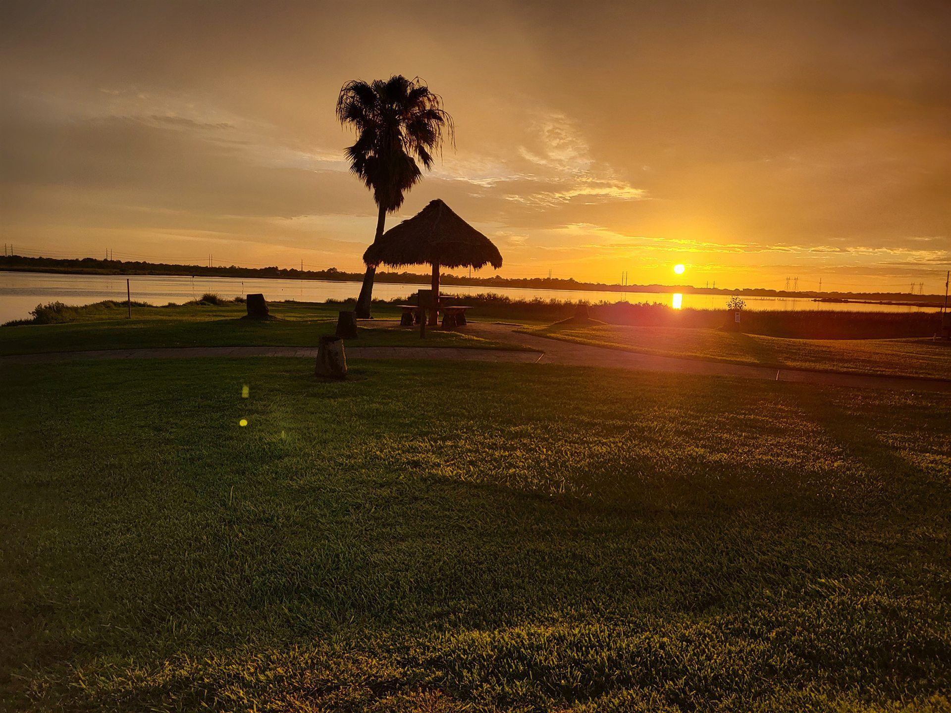 Golden Hour Sunset Over the Bayside Lawn & Waterfront Palapa